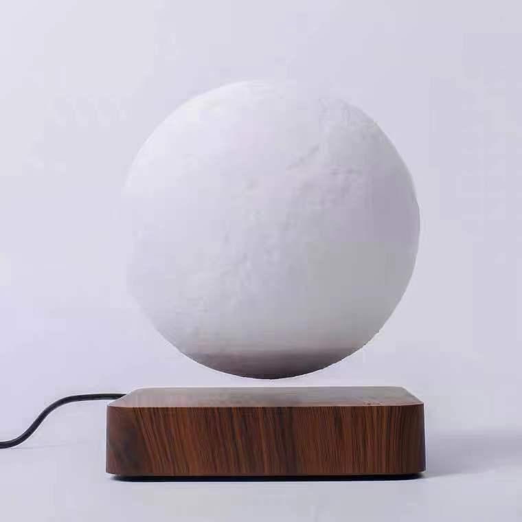 Magnetic levitation table lamp with 3D printed moon night light suspended above wooden base