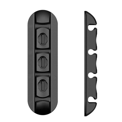 Black desktop charging magnetic data cable organizer on a table